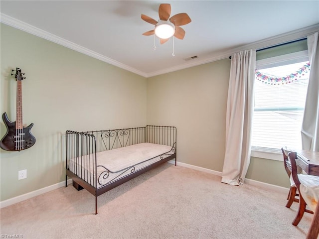 bedroom featuring light carpet, ceiling fan, and crown molding