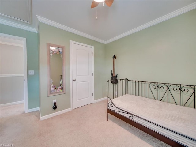 bedroom featuring ornamental molding, light carpet, and ceiling fan