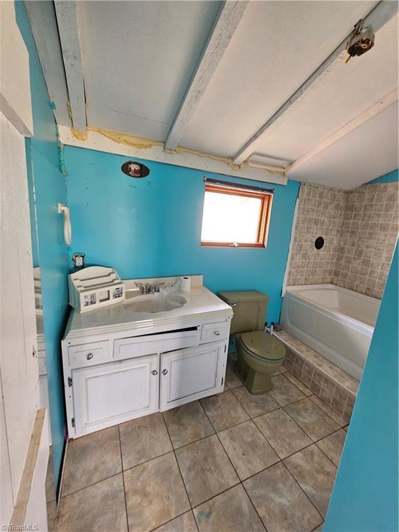 full bath featuring shower / bathing tub combination, toilet, tile patterned flooring, and vanity