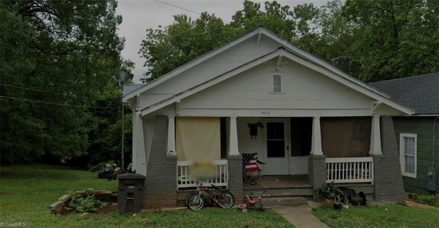 bungalow-style house with covered porch and a front yard