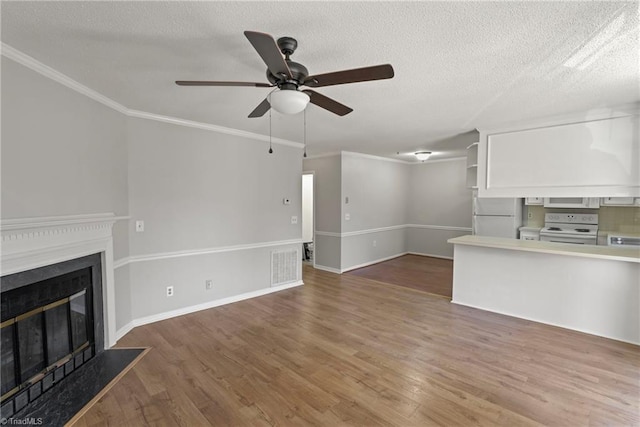 unfurnished living room with ornamental molding, a textured ceiling, and dark hardwood / wood-style flooring