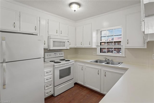 kitchen featuring sink, white appliances, dark wood-type flooring, white cabinetry, and a textured ceiling