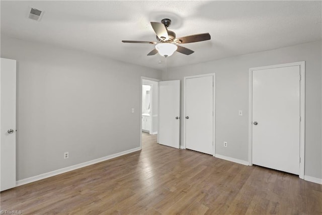 unfurnished bedroom with hardwood / wood-style flooring and ceiling fan