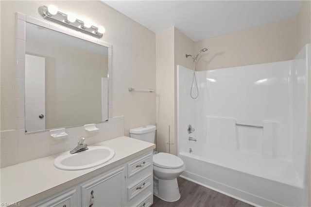 full bathroom with shower / tub combination, vanity, toilet, and hardwood / wood-style floors