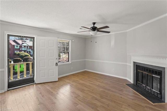 entrance foyer featuring ceiling fan, hardwood / wood-style flooring, ornamental molding, and a textured ceiling