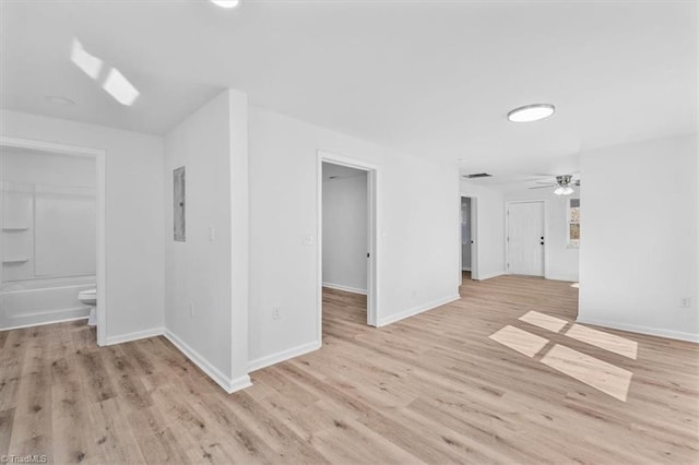 interior space with ceiling fan, electric panel, and light hardwood / wood-style floors