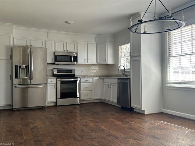 kitchen with stainless steel appliances, tasteful backsplash, white cabinets, and dark wood-style floors