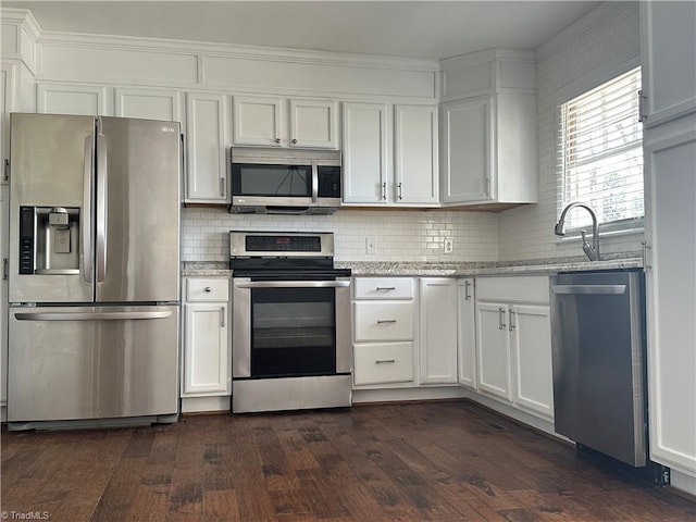 kitchen featuring appliances with stainless steel finishes, dark wood-style flooring, and white cabinets