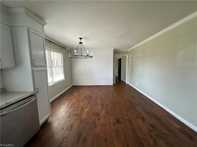 unfurnished dining area with dark wood-style flooring, an inviting chandelier, ornamental molding, brick wall, and baseboards