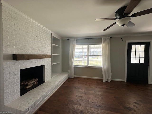 unfurnished living room with built in shelves, a fireplace, ornamental molding, wood finished floors, and baseboards