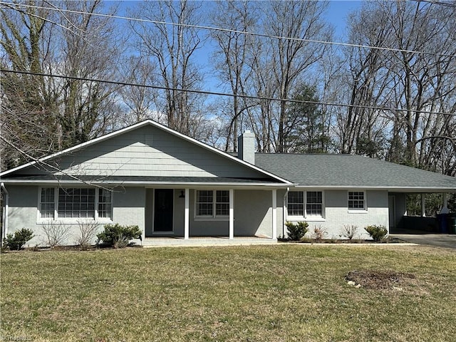 ranch-style house with brick siding, a chimney, a carport, and a front yard