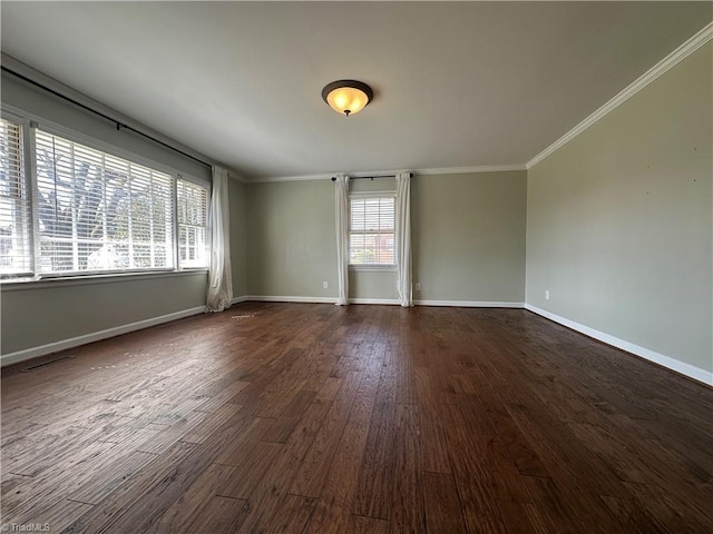 spare room featuring ornamental molding, dark wood-type flooring, visible vents, and baseboards