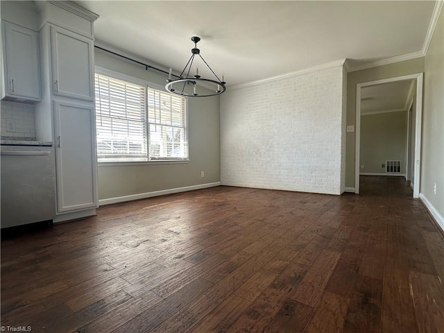 unfurnished dining area with dark wood-style floors, visible vents, ornamental molding, and brick wall