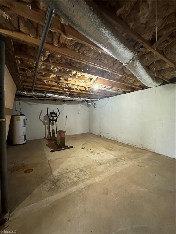 unfinished basement featuring water heater