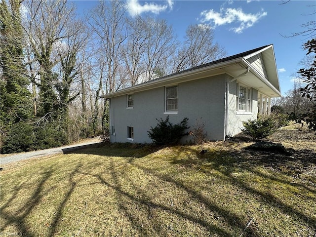 view of home's exterior featuring a lawn and stucco siding