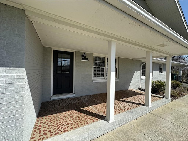 property entrance with brick siding