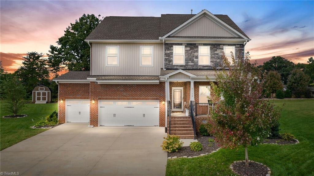 craftsman house featuring a garage and a yard