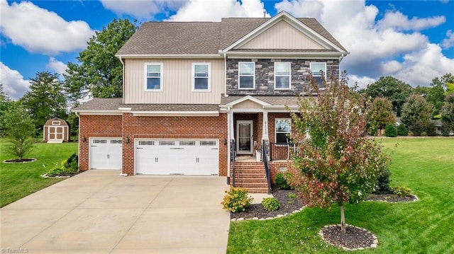 craftsman house featuring a storage shed, a garage, and a front yard