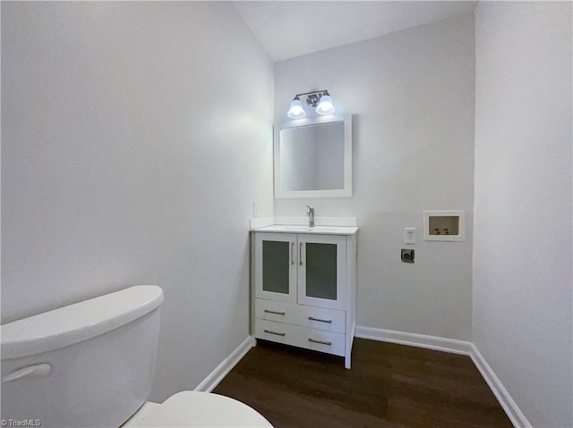 bathroom with vanity, hardwood / wood-style floors, and toilet