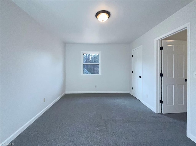 empty room featuring dark carpet