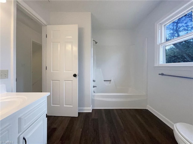 full bathroom featuring vanity, wood-type flooring,  shower combination, and toilet