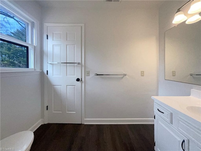 bathroom with vanity, wood-type flooring, and toilet