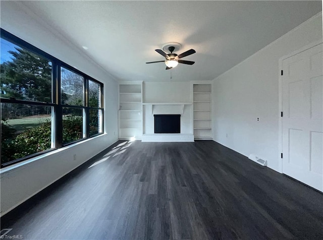 unfurnished living room featuring ceiling fan, built in features, and dark hardwood / wood-style flooring