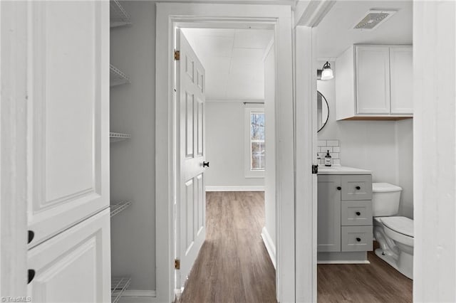 bathroom featuring hardwood / wood-style flooring, vanity, and toilet