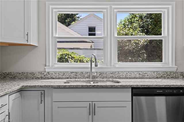 4108 Walker Ave, Greensboro, NC 27407 - kitchen featuring dishwasher, plenty of natural light, white cabinets, and light stone countertops