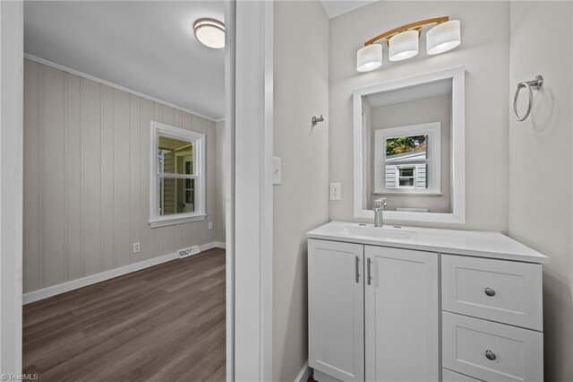 4108 Walker Ave, Greensboro, NC 27407 - bathroom with wood finished floors, vanity, and ornamental molding
