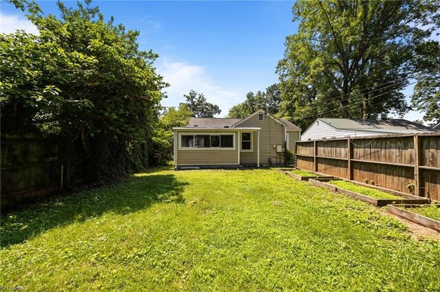 4108 Walker Ave, Greensboro, NC 27407 - fenced yard featuring a garden