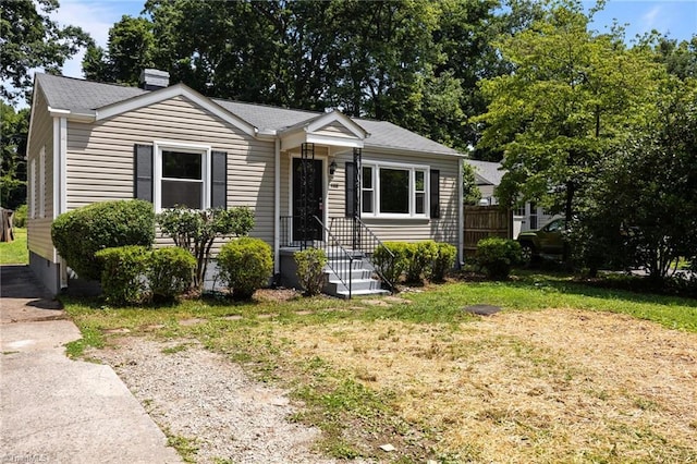 4108 Walker Ave, Greensboro, NC 27407 - bungalow with a chimney, a front yard, and roof with shingles
