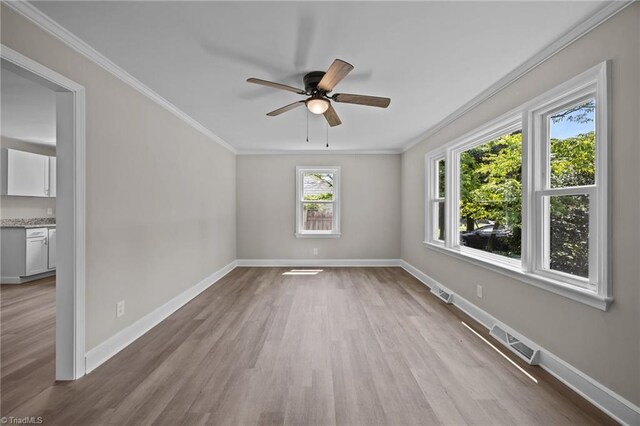 4108 Walker Ave, Greensboro, NC 27407 - empty room featuring crown molding, wood finished floors, and a ceiling fan