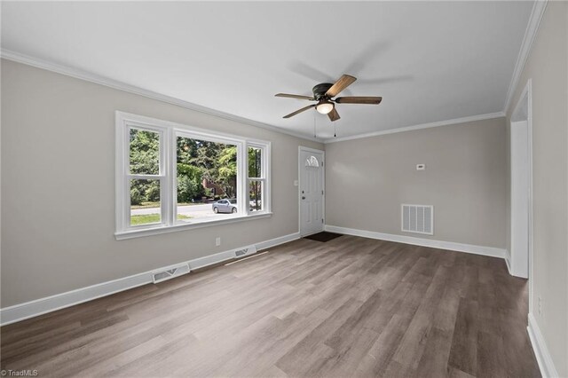 4108 Walker Ave, Greensboro, NC 27407 - empty room with a ceiling fan, crown molding, and wood finished floors
