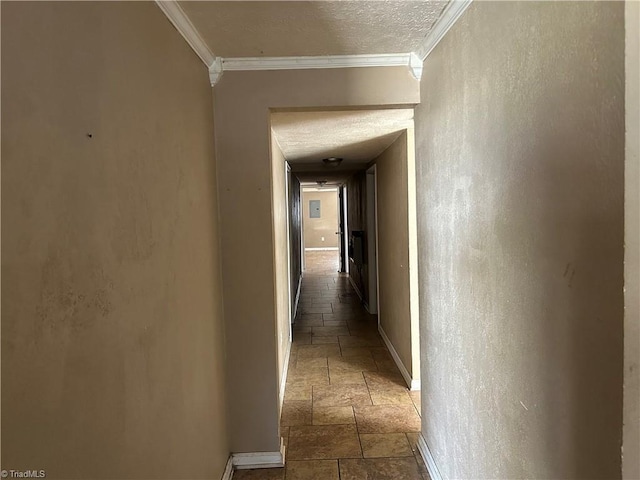 hall featuring crown molding, stone tile floors, a textured wall, a textured ceiling, and baseboards