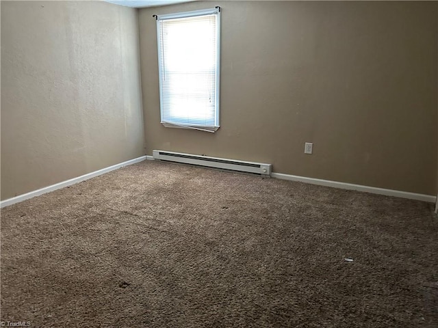 empty room featuring baseboards, carpet flooring, and baseboard heating