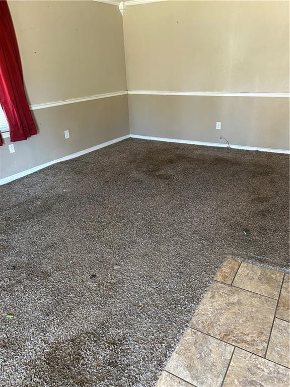 spare room with baseboards