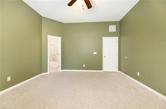 unfurnished room featuring vaulted ceiling, carpet, and ceiling fan