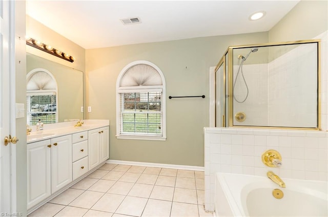 bathroom featuring tile patterned flooring, shower with separate bathtub, and vanity