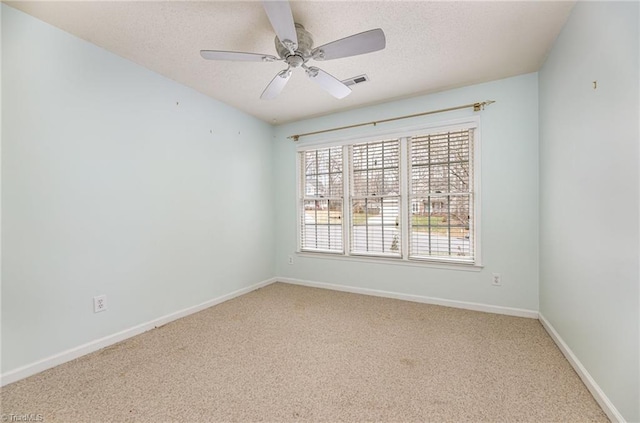 carpeted spare room with ceiling fan and a textured ceiling