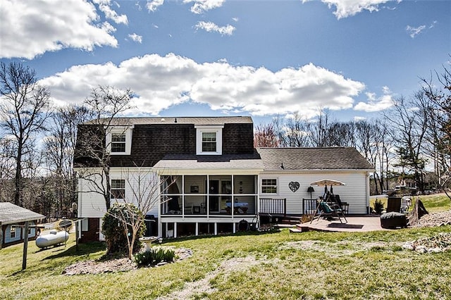 back of property with a sunroom, a patio area, a lawn, and roof with shingles