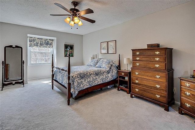 bedroom with light carpet, a textured ceiling, and a ceiling fan