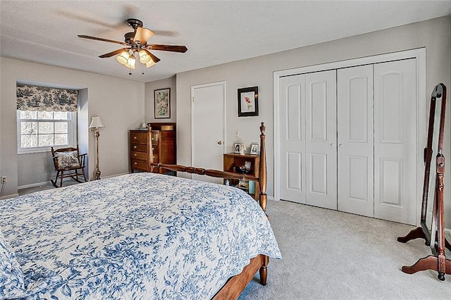 bedroom with a closet, light carpet, ceiling fan, and a textured ceiling