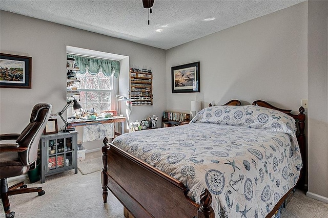 carpeted bedroom with a ceiling fan, a textured ceiling, and baseboards