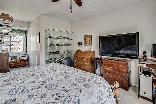 carpeted bedroom with a textured ceiling and ceiling fan