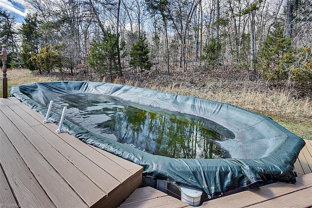 view of pool featuring a hot tub and a wooden deck