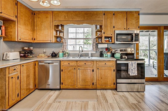 kitchen featuring appliances with stainless steel finishes, open shelves, a sink, and light countertops