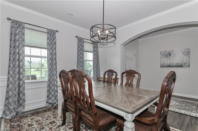 151 Outrigger Ln, Troutman, NC 28166 - dining area with arched walkways, wood finished floors, a chandelier, and crown molding