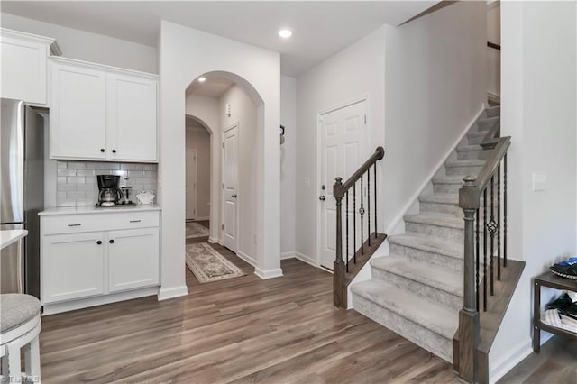 151 Outrigger Ln, Troutman, NC 28166 - foyer entrance featuring wood finished floors, stairs, arched walkways, baseboards, and recessed lighting