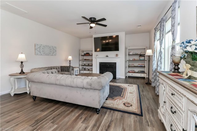 151 Outrigger Ln, Troutman, NC 28166 - living area featuring a ceiling fan, dark wood-style flooring, and a glass covered fireplace